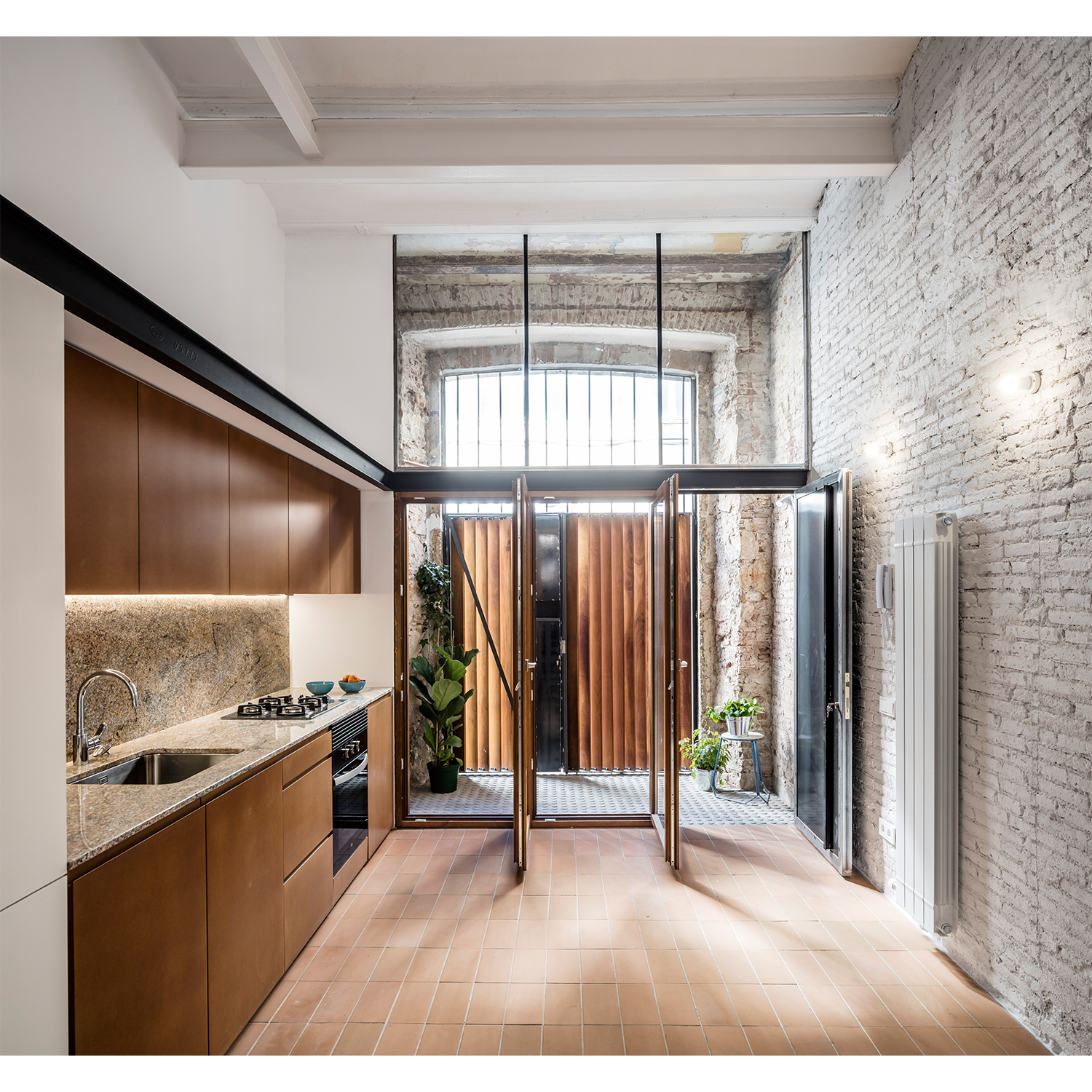 CRU innovative house renovation project in Barcelona. La Diana, a transformed local into a ground floor residence with two floors.